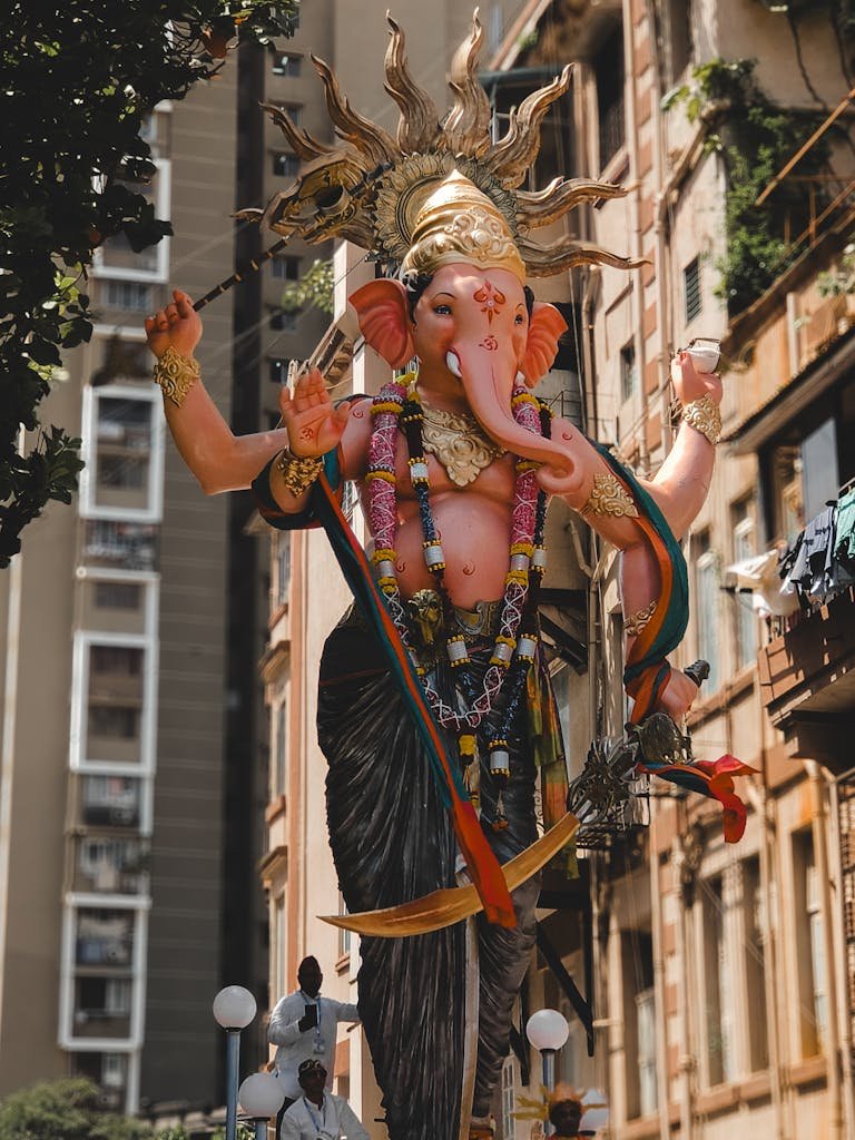 A vibrant Ganesh idol in a bustling Mumbai street during Ganesh Chaturthi festival.