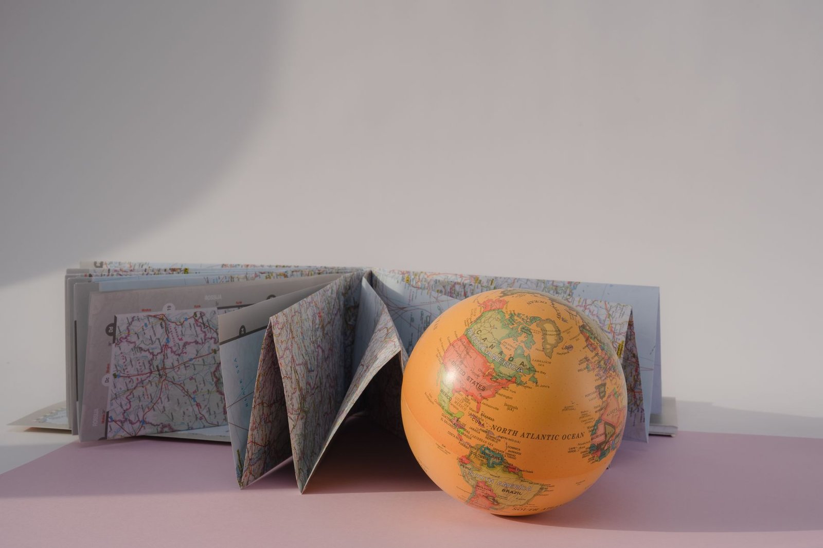 Geography GK Questions for Competitive Exams: 100+ Questions with Free PDF 7 paper map and a globe on the white surface